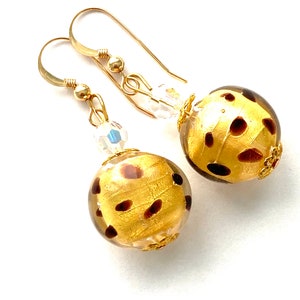 Murano glass  earrings with gold animal pattern beads Swarovski crystal and gold fill wires.