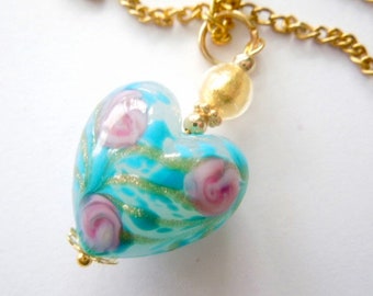 Murano glass pendant with blue and gold floral Murano glass heart bead and gold chain.