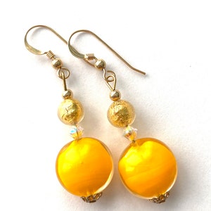 Murano glass earrings with yellow and gold Murano glass beads Swarovski crystal and gold filled wires.