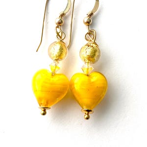 Murano glass earrings with yellow and gold Murano glass heart beads Swarovski crystal and gold filled wires.