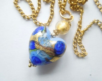 Murano glass pendant with blue and gold Murano heart bead and gold chain.