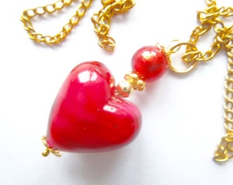 Murano glass pendant with red Murano heart and gold chain.