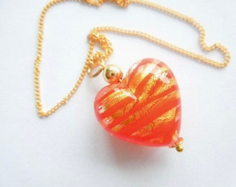 Murano glass pendant with red and gold Murano Glass heart and gold chain.