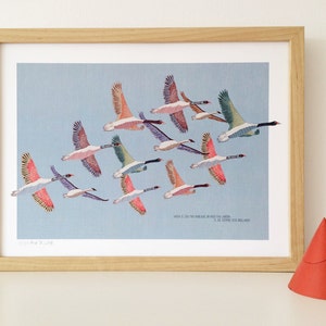 May include: A framed print of a flock of geese flying in formation against a light blue sky. The geese are depicted in various shades of pink, blue, and green. The print is titled "When I.C. On The Island In The Arctic Ocean" and is signed "C.R. ETHERIDGE 2018".