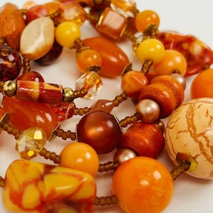 YOUR LITTLE LANTERNS Peachy Tones Dominate This Long Necklace of Vintage Glass, Resin , and Wood