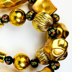 OF LIVING GOLD Big Gold-Tone Vintage Beads in Metal and Resin Alternate with Vintage Black Millefiori Beads with the Appearance of Flowers