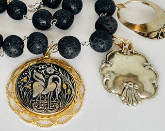 KLEPETAN AND MALENA A Pair of Storks, Hefty Mixed Metal Damascene Pendants Hang from Black Lavastone Balls