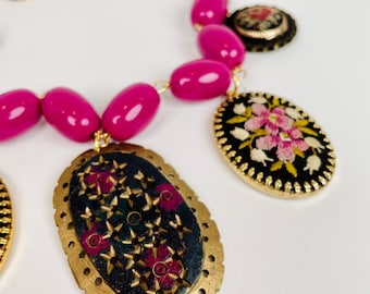 GILD THE LILY Magenta Pillow Beads Support Black and Purple Flower Pendants in Embroidery, Resin, and Cloisonné