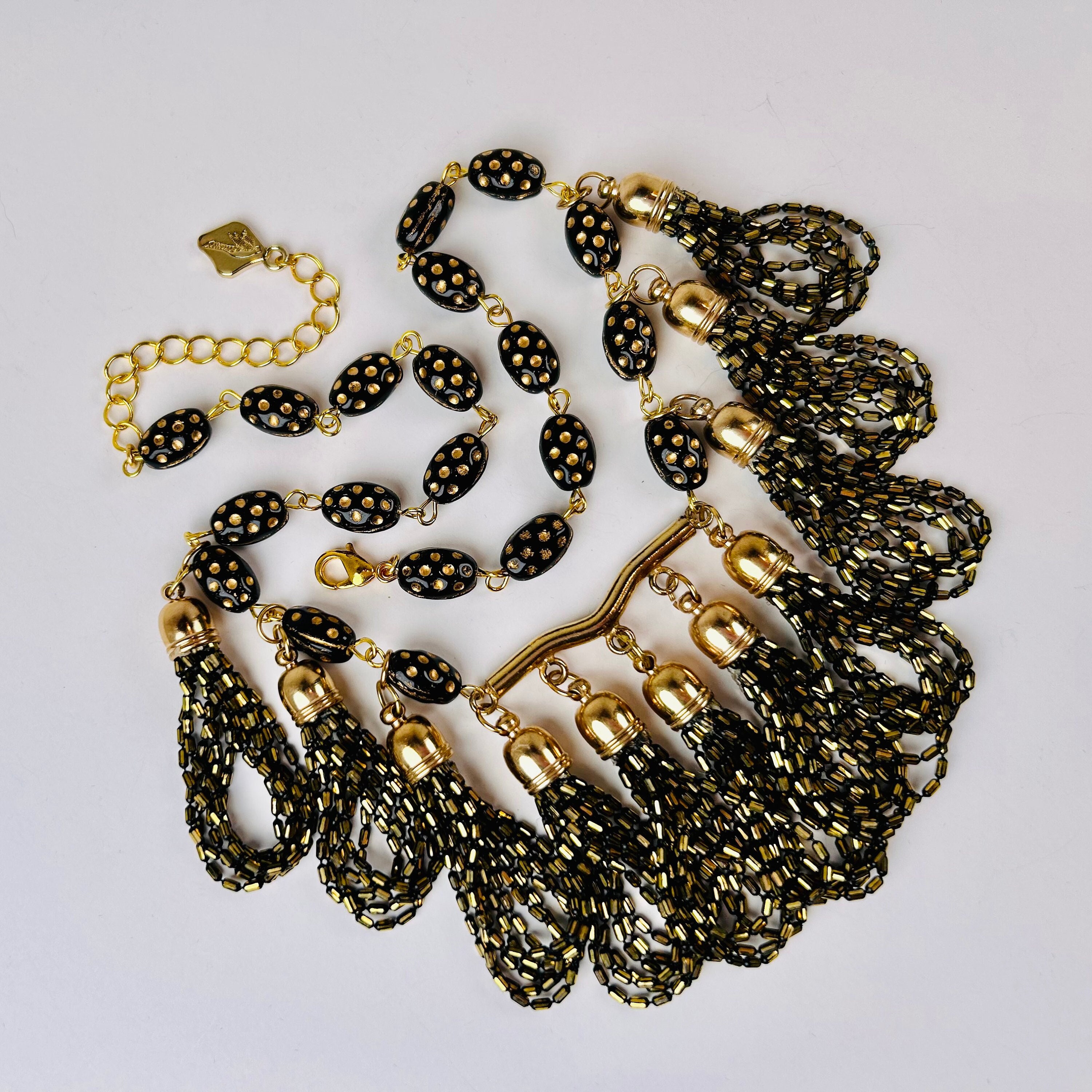 ON THE FRINGE Bespoke Tassels in Black and Brass Hang from Vintage Black and Gold Dotted Glass Beads