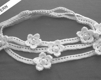 May include: White crocheted necklace with multiple strands and flower accents. Each flower has a small pearl bead in the center.