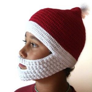 May include: A red and white crocheted Santa hat with a white crocheted beard. The hat has a white pom-pom on top.