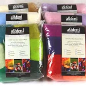 May include: Assortment of Ashford felting wool in various colors, including green, blue, pink, red, and white. Each bag contains a blend of wool fibers for felting projects.
