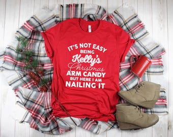 It's Not Easy Being "Custom Name" Christmas Arm Candy, But Here I am Killing It Shirt. Super Soft Unisex T-Shirt. Custom Christmas Shirt.
