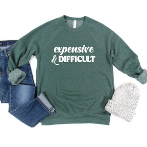 Puede incluir: Una sudadera verde con el texto "expensive & difficult" en letras blancas.