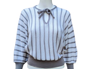 Vintage 70s or 80s gray and white sweater with tie at neck