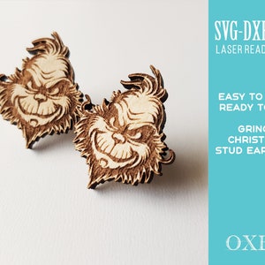 May include: A pair of laser cut wooden Grinch Christmas stud earrings. The earrings are brown and feature a cartoon image of the Grinch's face.