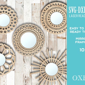 May include: Ten laser-cut mirror frames in various geometric designs. The frames are made of wood and have a natural finish. The text "SVG-DXF-EPS LASER READY FILES" is in the top right corner. The text "EASY TO MAKE READY TO CUT MIRROR FRAMES 10 OXEE" is in the bottom right corner.