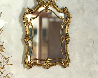 Vintage gilded wood wall mirror with a vintage bezel