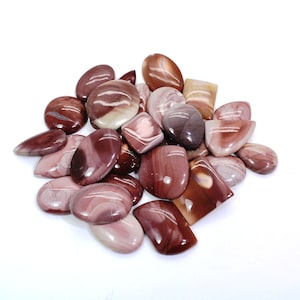 May include: A collection of 18 polished, natural, red and white banded agate cabochons. The cabochons are various shapes and sizes, with some being oval, round, and rectangular.