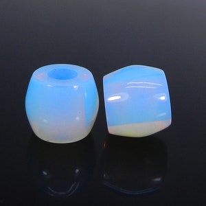May include: Two iridescent blue and white opal beads. The beads are round and have a smooth, polished finish.