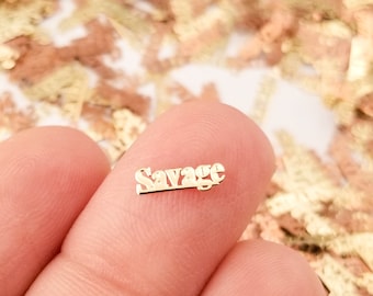 May include: Gold confetti with the word "Savage" in a bold font.