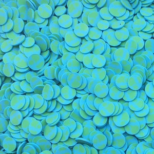 May include: A large quantity of blue and green confetti circles. The circles have a white polka dot pattern.