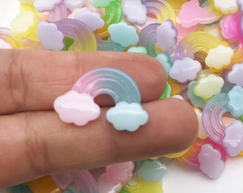 May include: A large pile of colorful rainbow and cloud shaped resin charms. The charms are translucent and have a glossy finish.