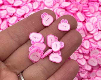 Pode incluir: Sprinkles de resina em forma de coelho rosa para artesanato. Os sprinkles são pequenos e têm um contorno branco.