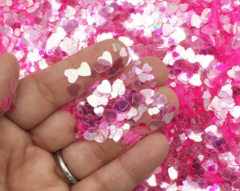 May include: Pink and iridescent heart-shaped glitter, perfect for crafting and adding sparkle to projects.