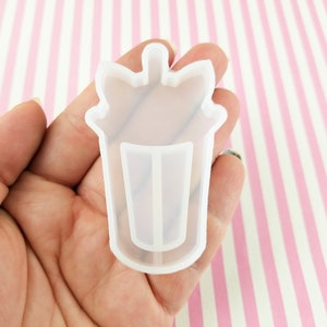 May include: A clear silicone mould shaped like a unicorn-themed milkshake cup with a straw. The mould is designed for making resin crafts.