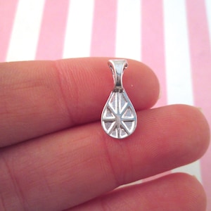 May include: Silver-toned pendant bail with a teardrop shape and a decorative design. The bail has a loop at the top for attaching a chain or cord.