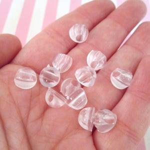 25 ganci per bottoni in plastica da incollare, H474