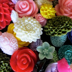 May include: Assortment of colorful, decorative, and unique flower-shaped buttons. The buttons are made of various materials, including plastic, metal, and fabric. The buttons are in a variety of colors, including red, pink, white, green, yellow, and blue.