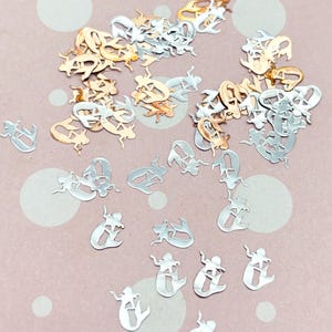 a pile of silver and gold letters and numbers