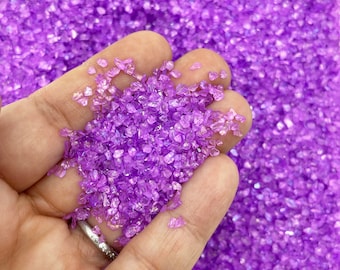 May include: A handful of iridescent purple glass glitter, perfect for crafting and adding sparkle to projects.