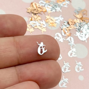 a person is holding a tiny silver ring