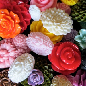 May include: Assortment of colorful, decorative buttons in various shapes and sizes, including flowers, swirls, and geometric patterns. The buttons are made of different materials, such as plastic, metal, and fabric.