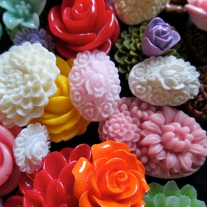 May include: Assortment of colorful resin cabochons in various flower and rose shapes. The cabochons are in shades of red, pink, orange, yellow, white, green, and purple.