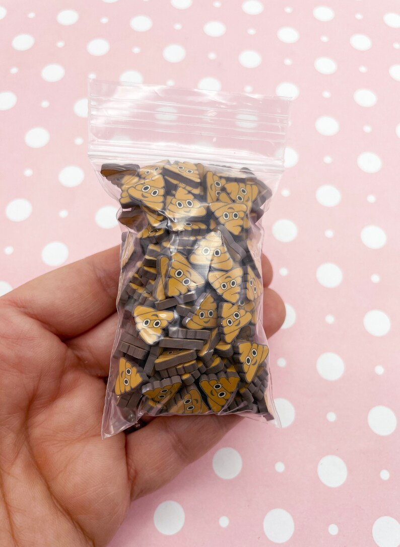 May include: A clear plastic bag filled with small brown and yellow resin poop emoji charms. The charms have a cute cartoon face with two eyes.