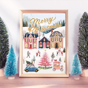 May include: A framed illustration of a winter village scene with the text "Merry Christmas" in gold lettering. The illustration features houses, trees, and people in a snowy landscape.