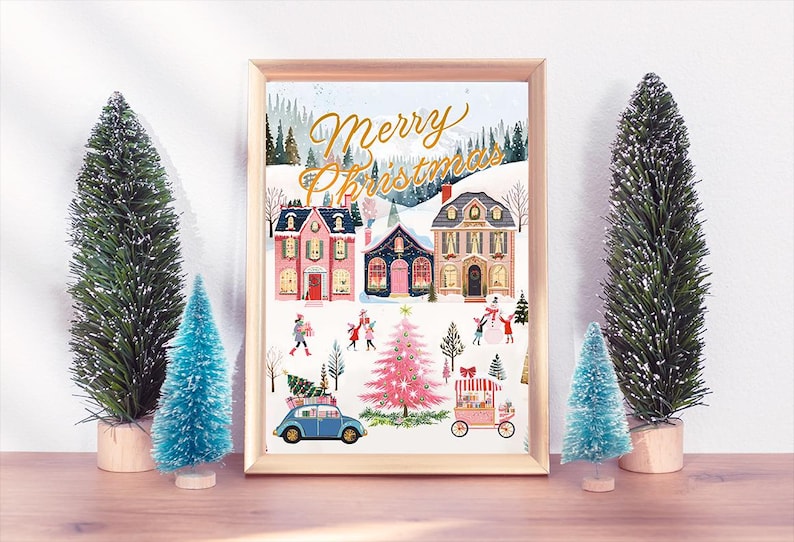 May include: A framed illustration of a winter village scene with the text "Merry Christmas" in gold lettering. The illustration features houses, trees, and people in a snowy landscape.