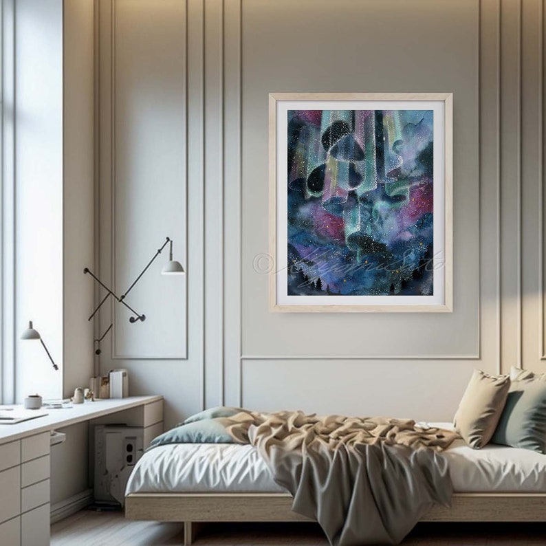 May include: A watercolor painting of a starry night sky with a cluster of abstract shapes in the center. The shapes are a mix of blues, purples, and greens, and they appear to be floating in the sky. The background is a dark blue with stars scattered throughout. The painting is framed in a light wood frame.