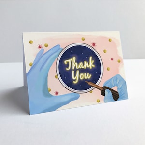 May include: A thank you card with a blue and gold illustration of a petri dish with the words "Thank You" inside. The dish is being held by two gloved hands, one of which is holding a pipette.