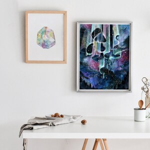 May include: A watercolor painting of a cluster of mushrooms with a starry night sky background. The mushrooms are painted in shades of blue, green, and purple, and the sky is filled with stars and a swirling aurora borealis. The painting is framed in a silver frame.