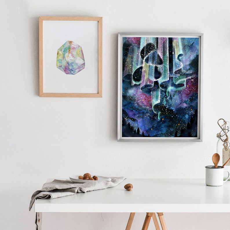 May include: A watercolor painting of a cluster of mushrooms with a starry night sky background. The mushrooms are painted in shades of blue, green, and purple, and the sky is filled with stars and a swirling aurora borealis. The painting is framed in a silver frame.