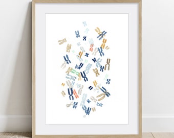 May include: A framed print featuring a watercolor illustration of chromosomes in various colors, including blue, orange, and tan, against a white background. The artwork is encased in a light brown wooden frame, suitable for a science-themed decor.