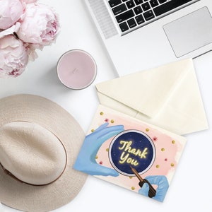 May include: A pink and gold thank you card with a blue gloved hand holding a petri dish with a glowing yellow "Thank You" message inside. The background is pink with gold dots and stars.