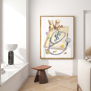 May include: Watercolor painting of a stethoscope and a veterinary symbol on a book with two cat paws on top. The book is surrounded by small flowers.