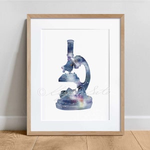 May include: A framed print of a watercolor illustration of a microscope with a galaxy design. The microscope is outlined in black and filled with a blue, purple, and white galaxy design.