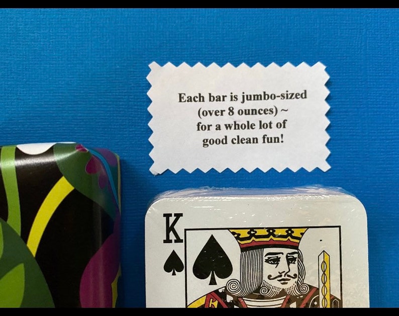 以下が含まれることがあります： 黒いスペードとKの文字が書かれた白いカード。カードはトランプの一部です。カードの上に「Each bar is jumbo-sized (over 8 ounces) ~ for a whole lot of good clean fun!」というテキストが書かれた白いラベルが見えます。
